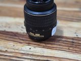 a black camera lens sitting on a wooden table