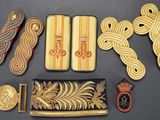many different types of brooches and pins on a table