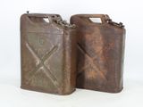 pair of old rusty metal jerry cans on a white background