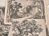 several old black and white pictures of trees and animals on a table