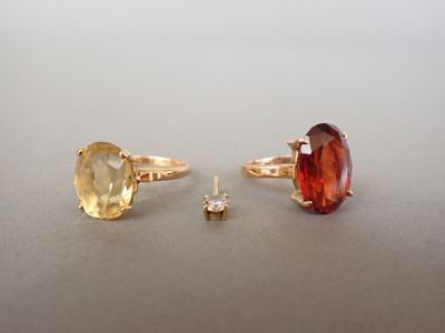 deux bagues et une bague sertie d'une pierre, posées sur une table