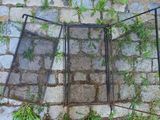 two windows that are open on the side of a brick wall