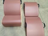 pair of pink leather recliners with wooden legs and arms