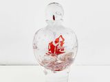 a clear glass bottle with a red ship inside of it