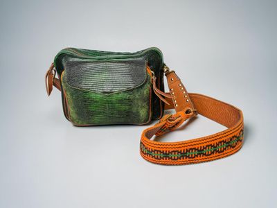 green and brown snake skin purse with leather strap