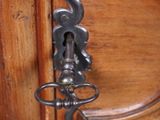 a close up of a door handle on a wooden door
