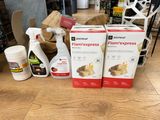 two boxes of cleaners and a bottle of cleaner sitting on a table