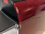 a close up of a red and black blender on a counter