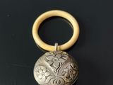 an antique silver locke with a wooden handle on a black surface