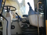 a back end of a construction vehicle with the driver ' s door open