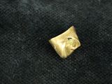 a close up of a gold ring on a black cloth