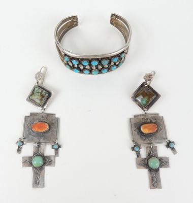 un gros plan sur un bracelet et un bracelet orné de pierres turquoise et orange