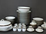 many different types of dishes and cups on the table