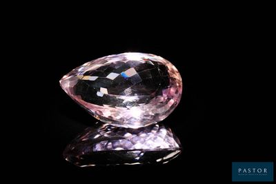 gros plan d'un diamant rose sur une surface noire