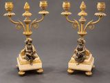 pair of antique brass candelabs with figurines on marble bases