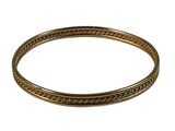 a close up of a gold bracelet on a white background