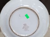 a white plate with a green sticker on it