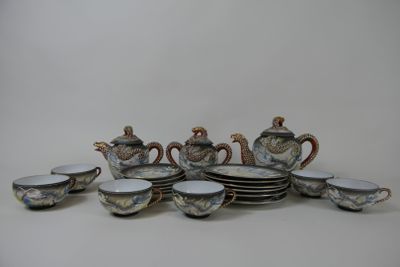 a lot of cups and saucers that are sitting on a table