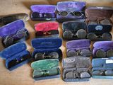 many pairs of glasses in a case on a table