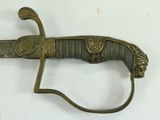 a very old sword that is laying on a table