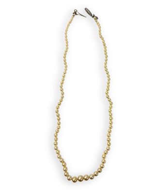 a close up of a necklace with gold beads on a white background