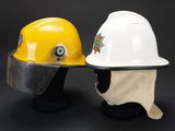 pair of yellow and white hard hats sitting on top of each other