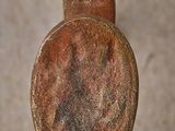 a close up of a wooden stick with a rusted surface
