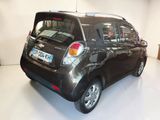 a small black car that is parked in a garage