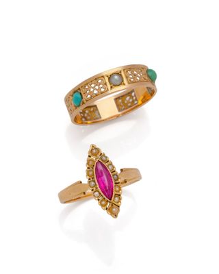 two gold rings and a pink stone ring on a white background