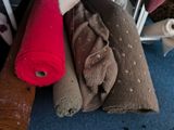 a pile of towels on the floor next to a chair