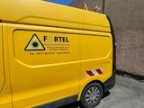 a yellow van that is parked in the parking lot