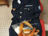 a uniform that is sitting on a chair next to a bag