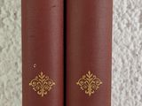 two red books sitting on top of each other on a table