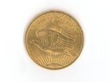a close up of a gold coin on a white surface