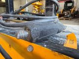 a close up of a forklift with a hose attached to it