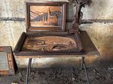 a small table with a picture on it next to a picture frame