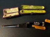 three different types of smoking pipes in a case