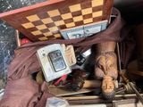 a wooden box filled with assorted items on a table