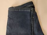 the back of a pair of jeans folded up on a table