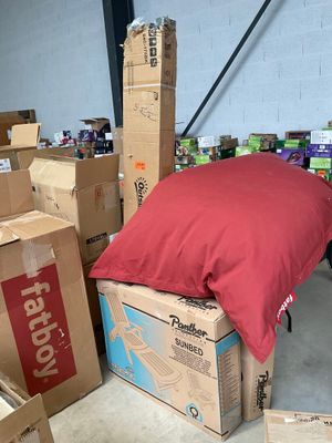 a pile of boxes and a pillow on the floor