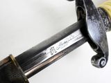 a close up of a sword with a yellow handle