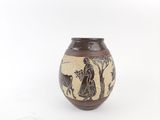 brown vase with black and white design of a man and a cow
