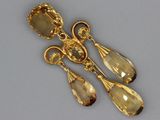 pair of gold tone earrings with a faceted citrine stone