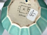 a close up of a vase with a label on it