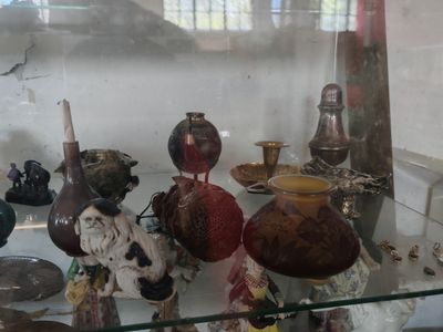 many different vases on display in a glass case
