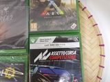 four xbox games are sitting on top of a basket on a table