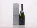 a bottle of champagne next to a box on a table