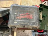 a tool box sitting on top of a pile of tools