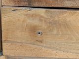 a close up of a wooden drawer with a clock on it