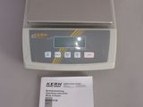 the electronic scale is sitting on the table next to the instruction book
